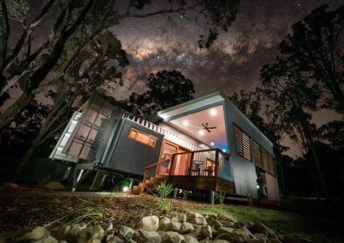 a house with a starry sky at night at Tuckers Lane Boutique Accommodation in Rothbury