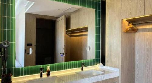 a bathroom with two sinks and a mirror at Tianrun International Hotel in Dunhuang