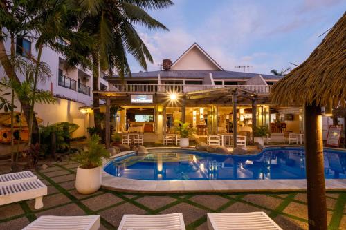a pool in front of a hotel at Aquarius On The Beach in Nadi