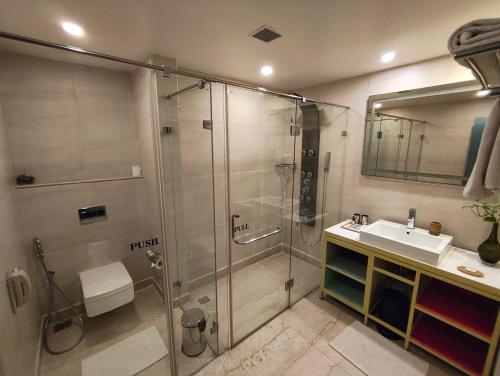 a bathroom with a shower and a sink at Zone By The Park, ORR, Chennai in Chennai