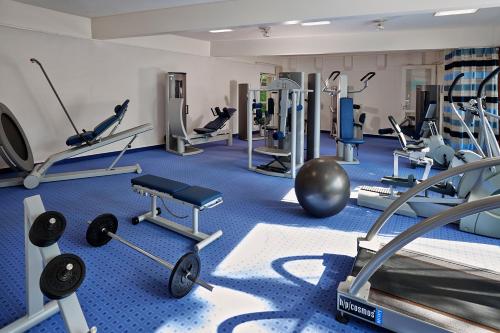 a gym with a lot of treadmills and machines at Ferien Residenz Bergfried in Hinterzarten