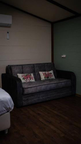 a couch in a room with two pillows on it at Vida Bhermon The Golan Trail in Majdal Shams