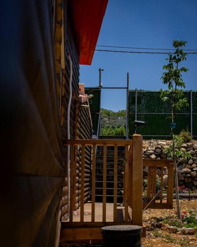 a wooden deck with a gate and a fence at Vida Bhermon The Golan Trail in Majdal Shams