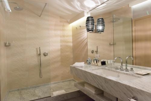 a bathroom with a sink and a shower at Baglioni Resort Alleluja in Punta Ala