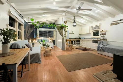 a living room with a couch and a table at Island Paradise - Private Waterfront Retreat in Scotland Island