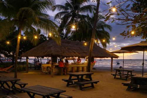 a restaurant on the beach at night with lights at Aquarius On The Beach in Nadi