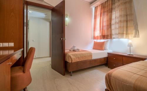 a small bedroom with a bed and a window at Zante Park Resort & Spa BW Premier Collection in Laganas