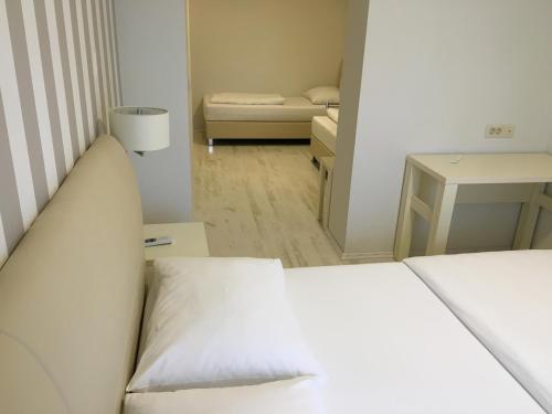 a small room with a bed and a small bedroom at Pansion Bencun in Međugorje