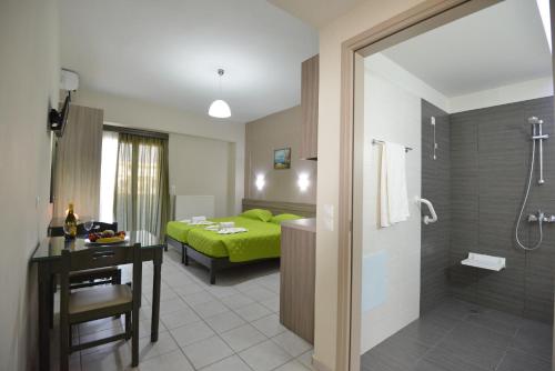 a hotel room with a bed and a bathroom at Vesperi Studios & Apartments in Rethymno Town