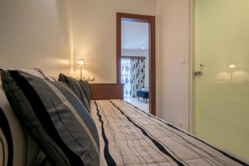 a large bed in a room with a window at Zante Park Resort & Spa BW Premier Collection in Laganas