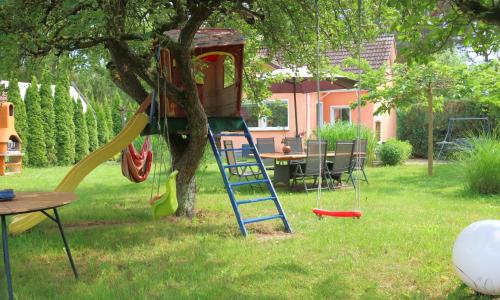 a tree house with a slide in a tree at Berlinurlaub im Grünen, Pool-Whirlpool beheizt, Sauna, Spielplatz, Grill, 3 Doppelzimmer in Blankenfelde