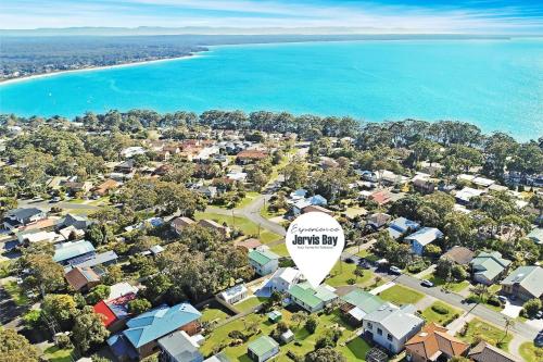 an aerial view of a suburb next to the ocean at Seaview by Experience Jervis Bay in Vincentia