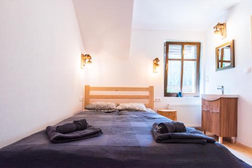a bedroom with a large bed with two pillows on it at Jókai Guesthouse in Tuşnad