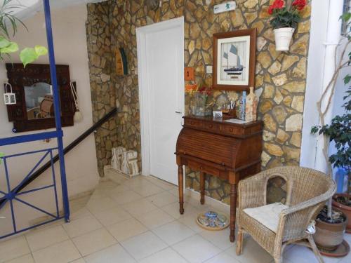 a room with a piano and a stone wall at Angelika Inn in Longá
