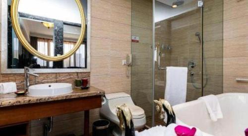 a bathroom with a sink toilet and a mirror at Hohhot Inner Mongolia Hotel in Hohhot