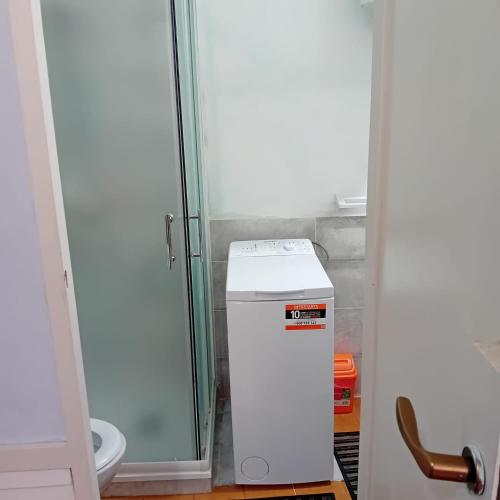 a bathroom with a toilet and a small refrigerator at Casa Milanesi in Monterosso al Mare