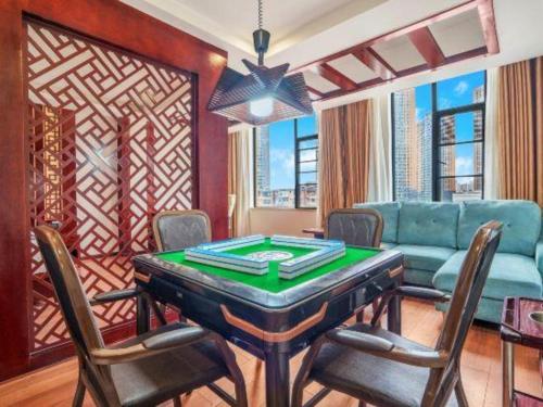 a living room with a poker table and a couch at GreenTree Inn Kunming Baiyun Road Tongde Plaza Branch in Kunming