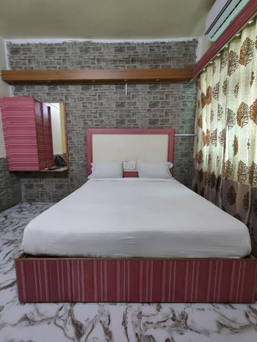 a bedroom with a large bed in a room at Hotel Shivtara in Nānded
