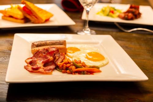 a plate of breakfast food with eggs and beans at 36 Alexander Guesthouse,Highlands,Harare in Highlands