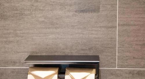 a black bench in a room with a wall at Atour Hotel Weihai Shidao in Dongshan