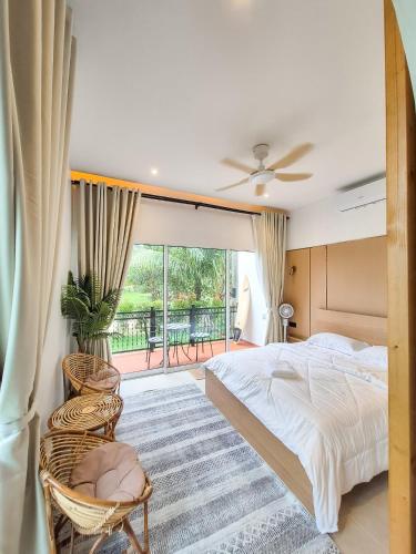 a bedroom with a bed and a balcony at Mersika Dua - Beachfront Villa 2BR Near To Mersing Jetty Town in Mersing