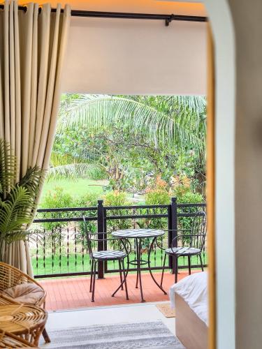 a room with a table and chairs on a balcony at Mersika Dua - Beachfront Villa 2BR Near To Mersing Jetty Town in Mersing
