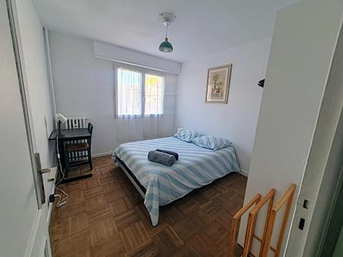 une petite chambre avec un lit et une table dans l'établissement Le Rossini, à Antibes