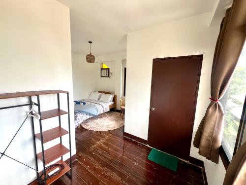 a bedroom with a bed and a staircase in a room at Isla Stays Siargao in General Luna