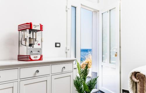a white kitchen with a window with the ocean at Seafront Villa Mijo by Villas Guide in Prigradica