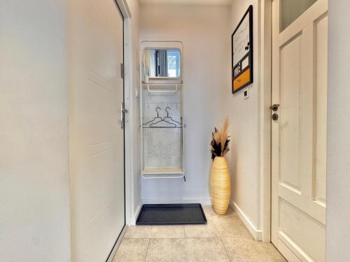 a hallway with a vase sitting next to a door at Tandem in Old Town - 24h self Check-In in Wrocław