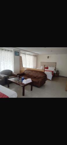 a living room with a couch and a coffee table at The Haizel Pine Wood Manali in Manāli
