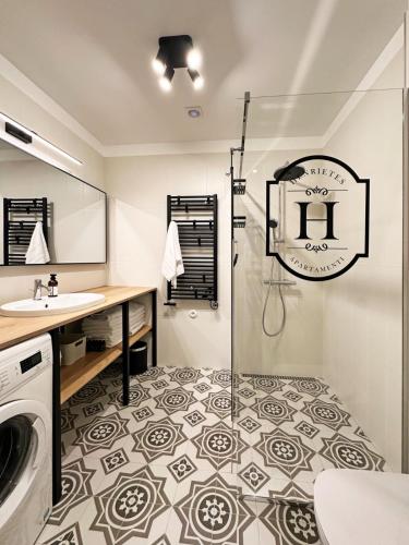 a bathroom with a shower and a sink at Henrietes Apartamenti in Kuldīga