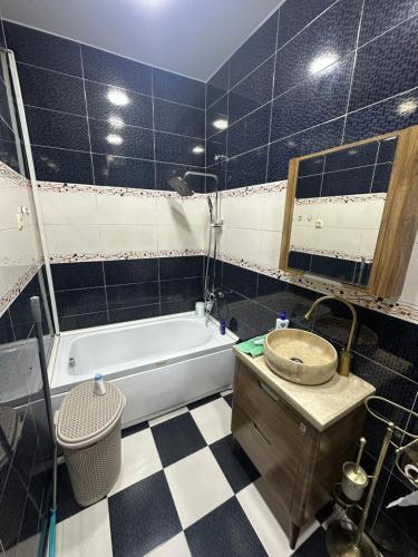 a bathroom with a tub and a sink at McDonald's in Itʼkhvisi