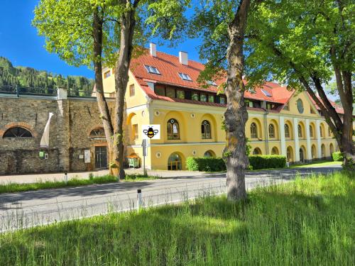 a large yellow building with a red roof at appartement bumblebee in Sankt Lambrecht