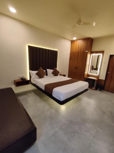 a bedroom with a large bed in a room at Hotel Shivtara in Nānded