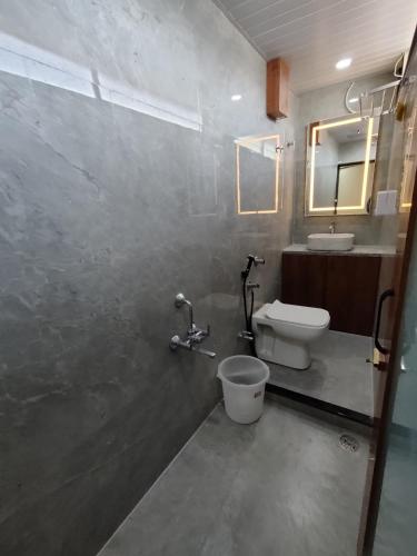 a bathroom with a toilet and a sink at Hotel Shivtara in Nānded