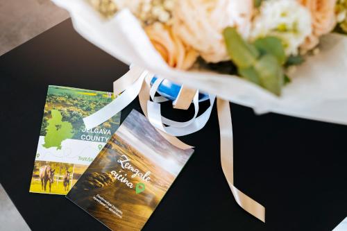 a book sitting on a table with a plate of food at Rikap Coliving Spaces in Jelgava