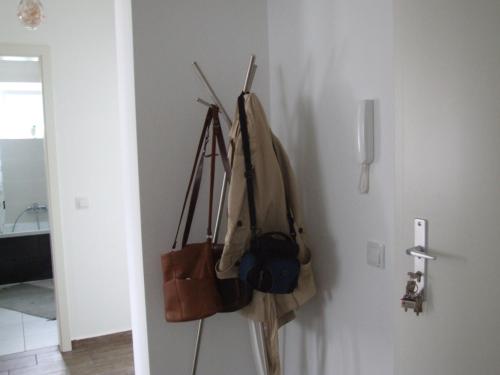 a group of purses hanging on a wall at Anca Apartment in Braşov