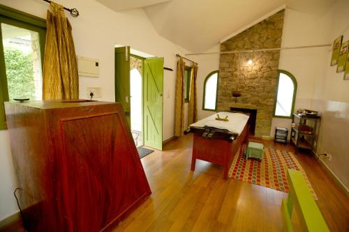 a living room with a table and a fireplace at Mountain Club Resort Munnar in Chinnakanal
