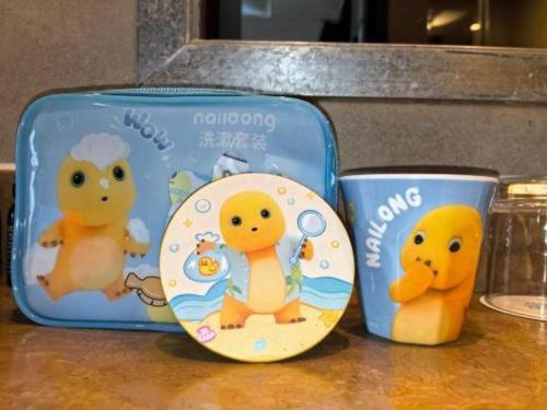 two toy items in a blue suitcase on a counter at Suzhou Qingshan Conference Center in Suzhou
