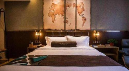 a bedroom with a large bed with a map on the wall at James Joyce Coffetel·Kaifeng Drum Tower in Kaifeng
