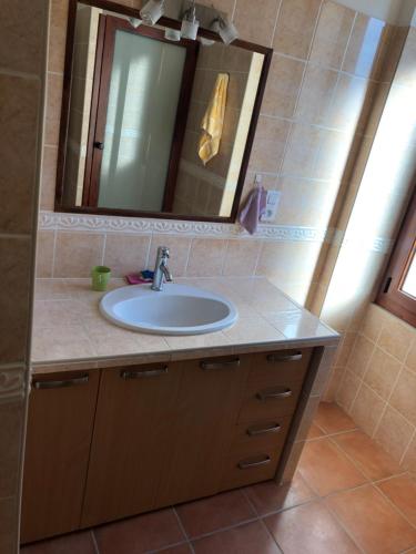 a bathroom with a sink and a mirror at Maison de village Frasseto in Frasseto