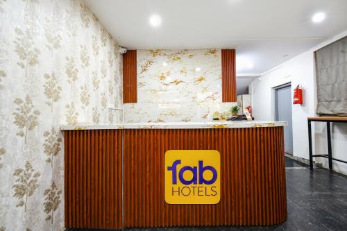 a fido hotel reception counter with a yellow sign on it at Fabhotel Unnam- Nr Amazon Hyderabad Campus, Financial District, Gachibowli in Hyderabad