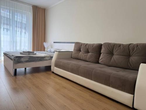 a living room with a couch and a coffee table at Просторі апартаменти у новобудові вул Вашингтона in Lviv