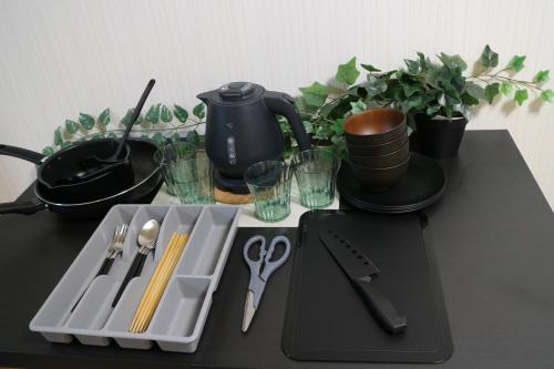 a table with a tray with utensils on it at お宿あびこシルバーハイツ in Osaka