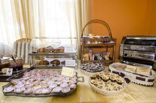 a display case filled with lots of donuts and pastries at Hotel Smeraldo in Lazise
