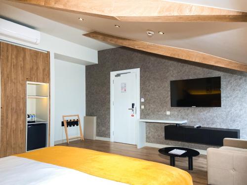 a bedroom with a bed and a tv on a wall at Dugi Hotel in Istanbul