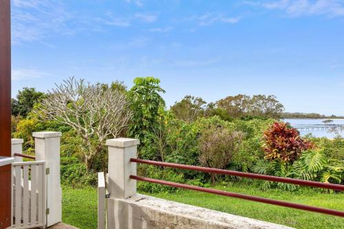 a porch with a fence and a view of the water at Sapphire Magic 1B in Urunga