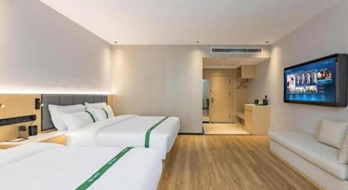 Ένα ή περισσότερα κρεβάτια σε δωμάτιο στο GreenTree Inn Hebei Langfang Bazhou Railway Station West Yingbin Road Express Hotel
