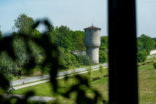 a view of a water tower from a window at Rikap Coliving Spaces in Jelgava
